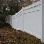 boundary white vinyl fence on property