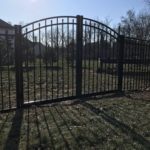 arched grand fence in backyard