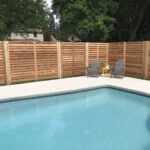 slatted wooden fence around pool