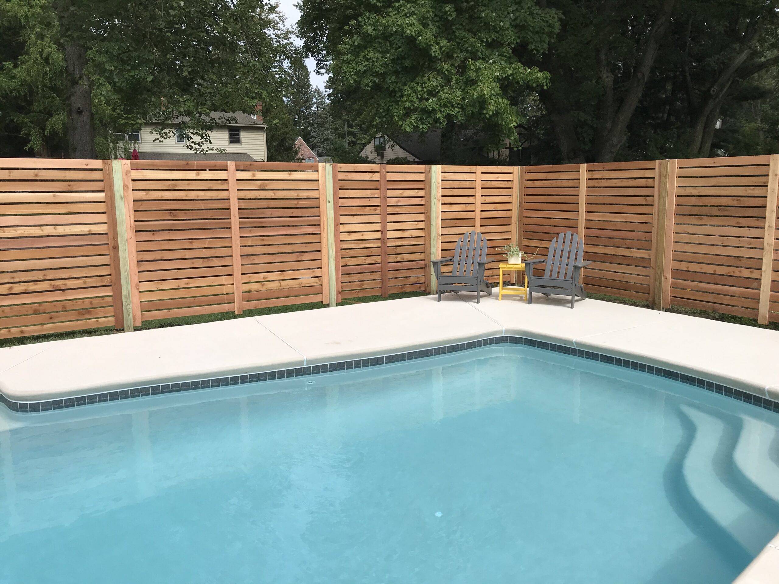 6 ft tall horizontal wooden fence around pool