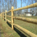 wooden split rail fence on driveway